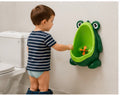 Toddler boy using SmartTot Frog Potty Trainer mounted on bathroom wall