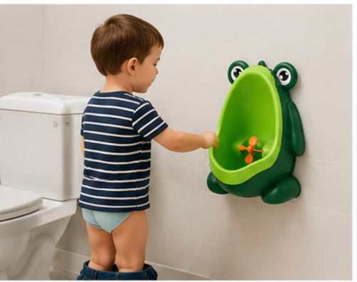 Toddler boy using SmartTot Frog Potty Trainer mounted on bathroom wall